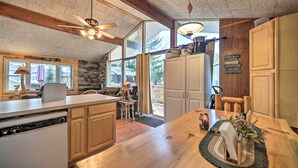 A spacious kitchen with wooden cabinets, a built-in dishwasher, and a large island. - Lake Pleasant Access! Speculator Cottage w/ Deck (Speculator)