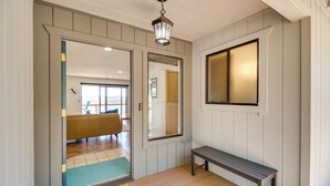 A hallway with a bench, a door leading to a room with a bench, and a mirror on the wall. - Idyllic Kelseyville Home w/ 2 Decks + Views! (Kelseyville)