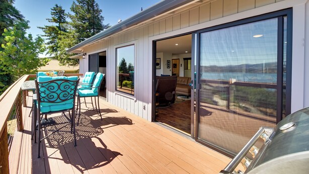A deck with outdoor furniture, a sliding glass door leading to a living area, and a view of the outdoors. - Idyllic Kelseyville Home w/ 2 Decks + Views! (Kelseyville)