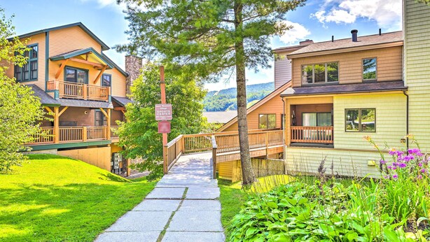 A residential area with a pathway leading to a sports center sign. - Comfortable Dover Apartment: Walk to Mt Snow! (West Dover)