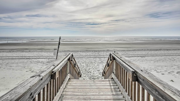 A wooden boardwalk leading to a beach with a cloudy sky. - Freshly Remodeled Beach House, Steps to Shore (Sunset Beach)
