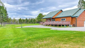 A lodge with a wooden exterior, a covered deck, and a well-maintained lawn. - Newcomb Retreat w/ Mountain Views & Fire Pit! (Newcomb)