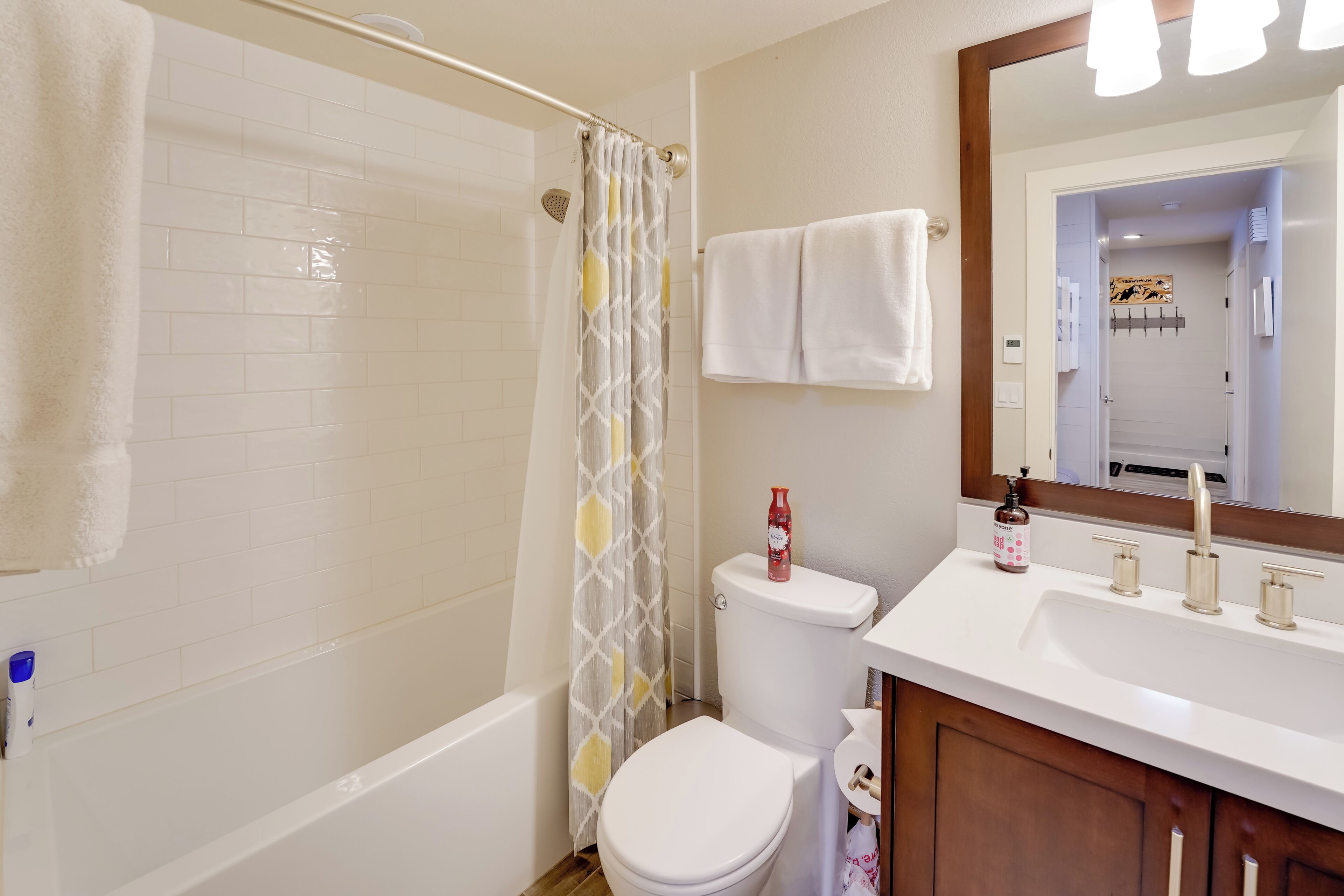 A bathroom with a bathtub, toilet, and sink.