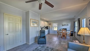 A spacious living room with a ceiling fan, a dining area with a table and chairs, and a kitchen in the background. - Serene West Cape May Getaway: Walk to Beach! (Cape May)