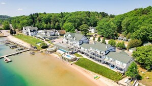 A large resort with multiple buildings, a marina, and a beach. - Pool + Hot Tub Access! Portage Lake Condo w/ Deck (Onekama)