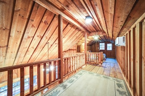 A wooden attic room with a wooden ceiling, a wooden railing, and a window. - Rustic Cabin w/ Mountain Views! Elevation 4,400 (Maggie Valley)