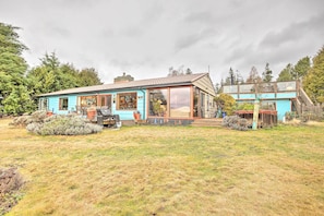 A two-story house with a large glass front and a blue exterior. - Private Waterfront Bellingham Estate! (Bellingham)