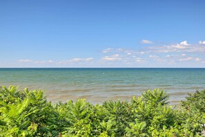 A coastal view with clear skies and calm waters. - Walk to Beach, Marina & Town! Lake Ontario Getaway (Sodus Point)
