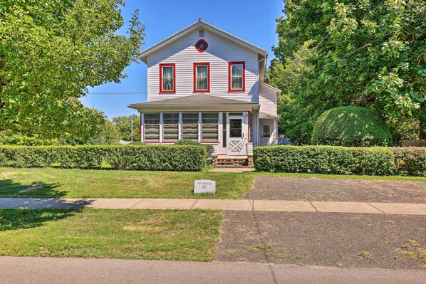 A two-story house with a front porch, a chimney, and a mailbox. - Walk to Beach, Marina & Town! Lake Ontario Getaway (Sodus Point)
