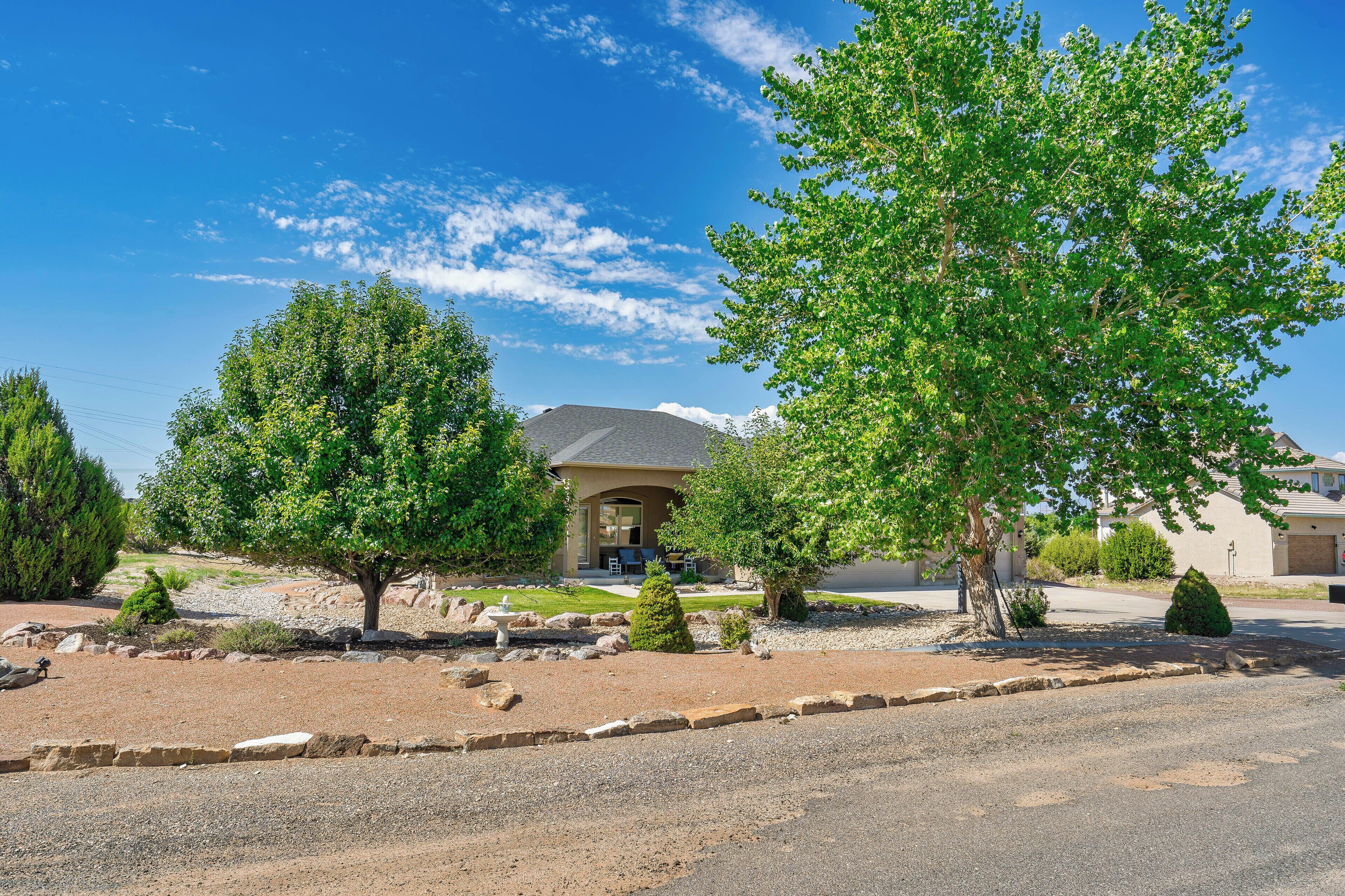 A residential property with a house, a driveway, and a well-maintained lawn.