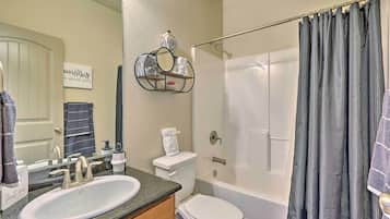 A bathroom with a sink, toilet, and bathtub.