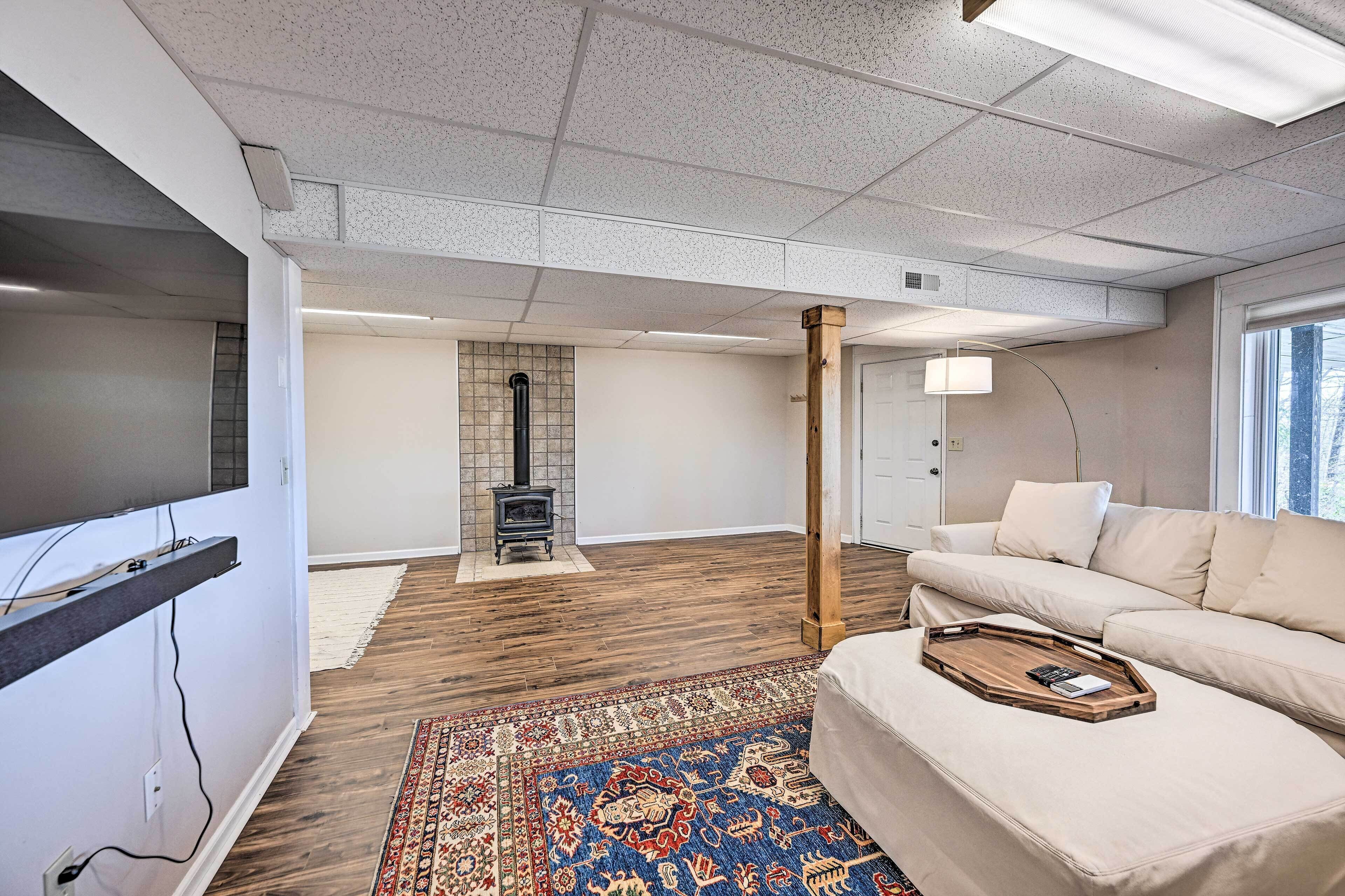 A modern living room with a fireplace, a sofa, and a wooden floor.