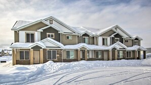 A row of modern, two-story houses covered in snow, with visible tire tracks in the snow. - Garden City Vacation Rental - 1 Mi to Beach! (Garden City)