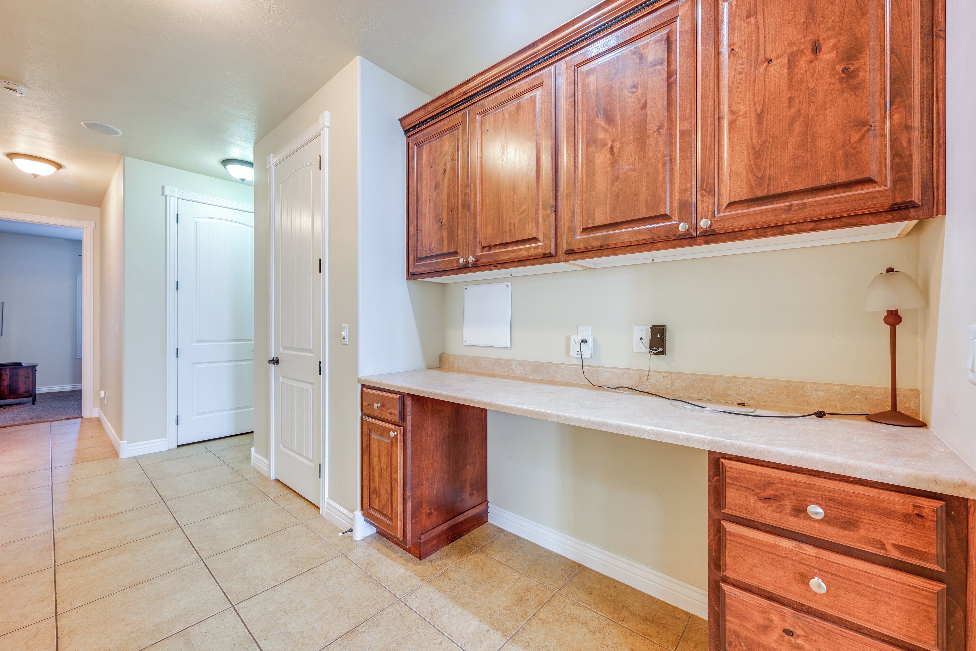 A kitchen with wooden cabinets, a countertop, and a sink.