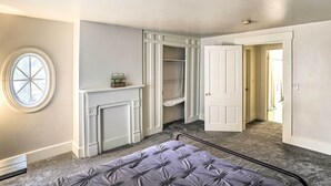 A bedroom with a bed, a closet, a fireplace, and a window. - Historic Troy Home Enjoyable Dining Steps Away (Troy)