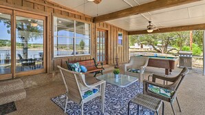 An outdoor patio with wicker furniture, a pool table, and a ceiling fan. - Private Dock - Waterfront Lake Brownwood Gem! (Brownwood)