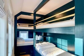 A bunk bed room with a window, a desk, and a chair. - Luxe Lakefront Getaway w/ Porch + Water View! (Dadeville)