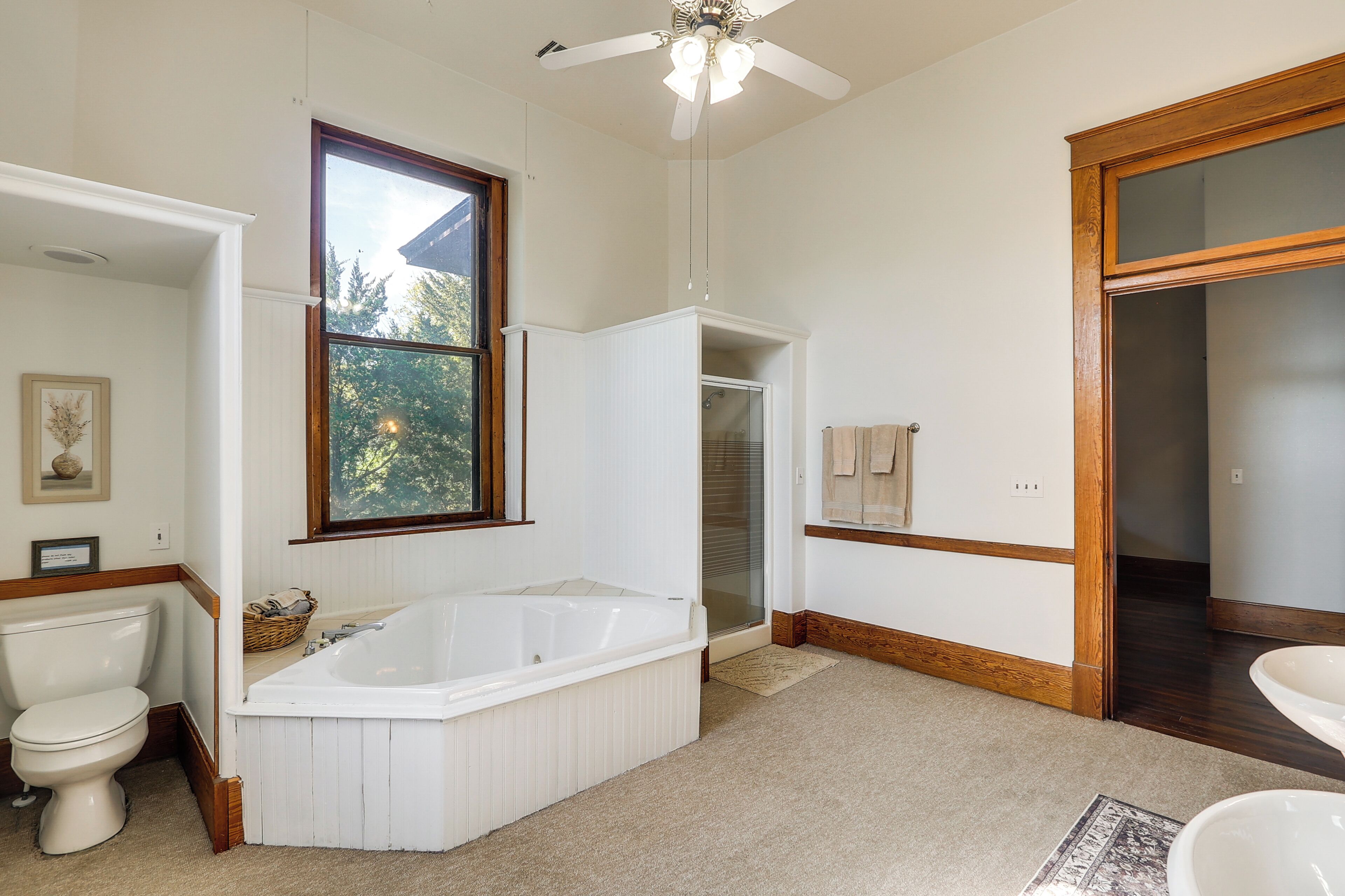 A bathroom with a bathtub, toilet, and sink.