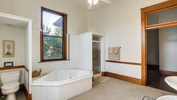 A bathroom with a bathtub, toilet, and sink.