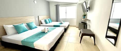 Deluxe Quadruple Room | Premium bedding, down comforters, Select Comfort beds, desk