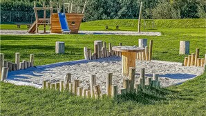 A playground with a slide and climbing structures. - Gorgeous (sta)caravan in Tzummarum (Tzummarum)