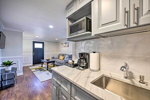 A modern kitchen with a marble countertop, stainless steel appliances, and a built-in sink. - Bay Shore Vacation Rental ~ 7 Mi to the Beach (Bay Shore)