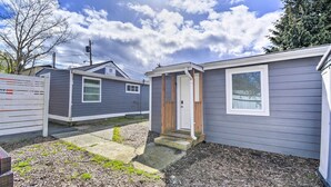 A row of mobile homes with a clear sky and a wooden fence in the foreground.
