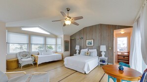 A bedroom with a bed, two chairs, a table, a ceiling fan, and a window with blinds. - Private Beach Access! Bayfront Cape May Cottage (Cape May Court House)