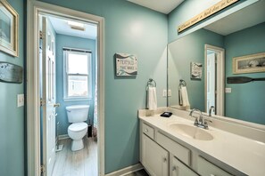 A bathroom with a light blue wall, a white sink, and a large mirror. - Coastal Home w/ Community Pool < 2 Miles to Beach! (Corolla)