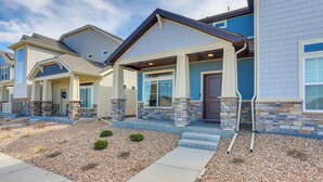 A residential building with a stone facade, a front porch, and a driveway. - Colorado Retreat Near Hiking, Golfing & Fishing! (Commerce City)