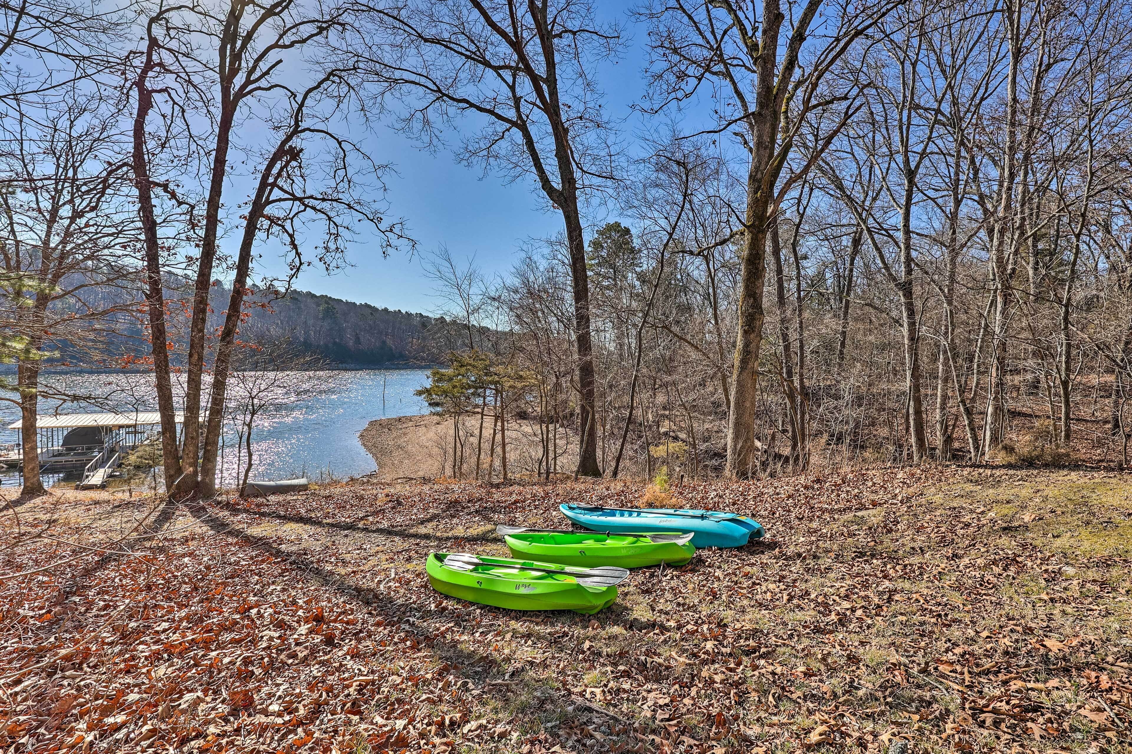 A lakeside view with kayaks and a dock.