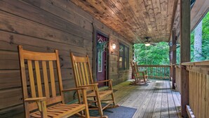 A wooden cabin with a porch featuring rocking chairs and a door with a red frame. - Charming Mtn Cabin 2 Mi From Downtown Boone! (Boone)