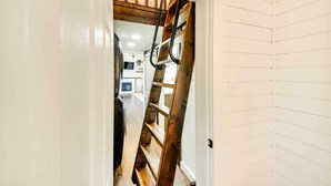 A hallway with a wooden ladder leading to a loft area. - Contemporary Cabin w/ Mountain Views & Deck (Bonners Ferry)