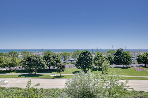 A parking lot with trees and a clear view of the ocean. - Eclectic Manitowoc Vacation Rental Near Marina! (Manitowoc)