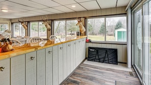 A kitchen with wooden cabinets, a wooden countertop, and mounted deer heads. - Cozy Cass City Retreat w/ Spacious Deck! (Cass City)
