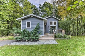 A two-story house with a front porch, a small deck, and a stone pathway leading to the entrance. - Cozy White Lake Home w/ Patio, Deck & Grill! (White Lake)