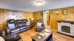 A cozy living room with a leather sofa, a recliner, and a coffee table. A fireplace is visible in the background. - Burkesville Vacation Rental - 5 Mi to the Lake! (Burkesville)