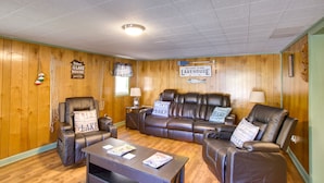 A cozy living room with leather sofas, a coffee table, and a sign reading "Welcome to our Lake House." - Burkesville Vacation Rental - 5 Mi to the Lake! (Burkesville)