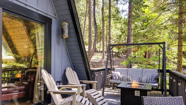 A deck with Adirondack chairs, a sofa, and a fire feature. - Decks, Grills + Fire Pit: Camp Connell Hideaway! (Arnold)