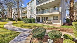 A multi-story residential building with balconies, a landscaped garden, and a curved driveway. - Beautiful St George Condo ~ 5 Mi to Downtown! (St. George)