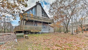 A two-story house with a balcony and a covered porch area. - Lake Harmony Vacation Rental w/ Hot Tub & Views! (Lake Harmony)