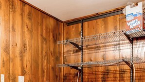 A laundry room with wooden walls, two white washers, a metal drying rack, and a trash can. - Lake Harmony Vacation Rental w/ Hot Tub & Views! (Lake Harmony)