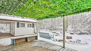 A wooden deck with a bench and a covered area with a bench. - Large Greeley House w/ 2 Game Rooms + Yard! (Greeley)