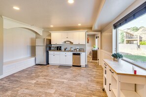 A modern kitchen with white cabinetry, a built-in microwave, and a dishwasher. - La Verkin Family Apartment - 21 Miles to Zion! (La Verkin)