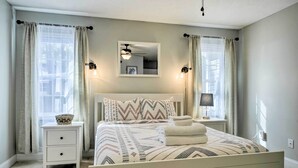 A bedroom with a bed, nightstands, a mirror, and curtains. - Idyllic Pinehurst Home, Near Golf Course! (Pinehurst)
