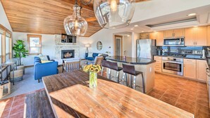A modern kitchen with a central island, stainless steel appliances, and a wooden ceiling. - Mckees Beach House w/ Ocean Views, Hot Tub! (Stanwood)
