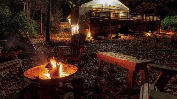 A cabin with a deck, a fire pit, and outdoor seating. - Lake Harmony Estates Family Home w/ Beach Access (Lake Harmony)