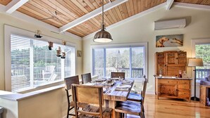 A dining area with a wooden table, chairs, and a ceiling with exposed beams. - Private Rockaway Beach Retreat: 2 Blocks to Ocean! (Rockaway Beach)