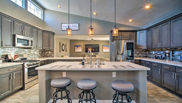 A spacious kitchen with a large island, stainless steel appliances, and pendant lighting. - Modern El Paso Home w/ Backyard & Fire Pit! (El Paso)
