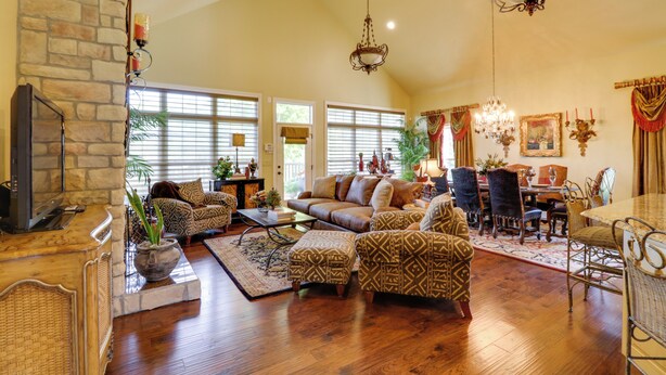 A spacious living room with a fireplace, comfortable seating, a dining area, and large windows allowing natural light. - Mountain Home Gem on River! 0.4 Mi to Boat Launch (Mountain Home)